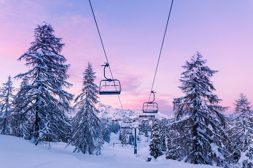 snowy mountain with snow covered trees, ski lift running in the middle