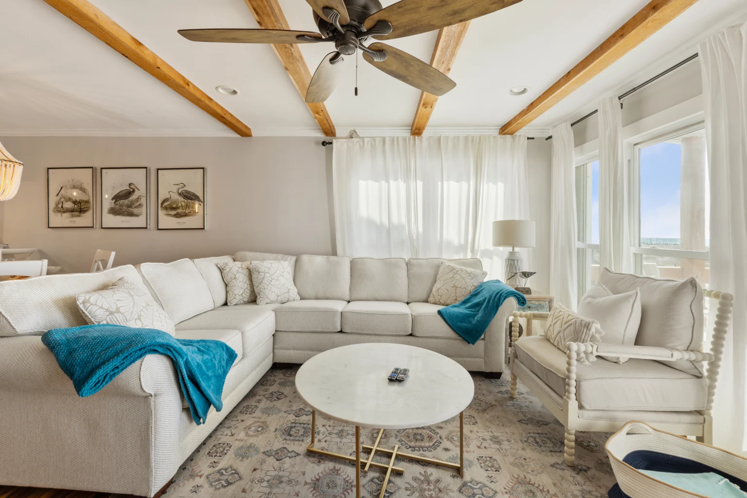 Living room with white sectional and beamed ceiling, SouthWind East