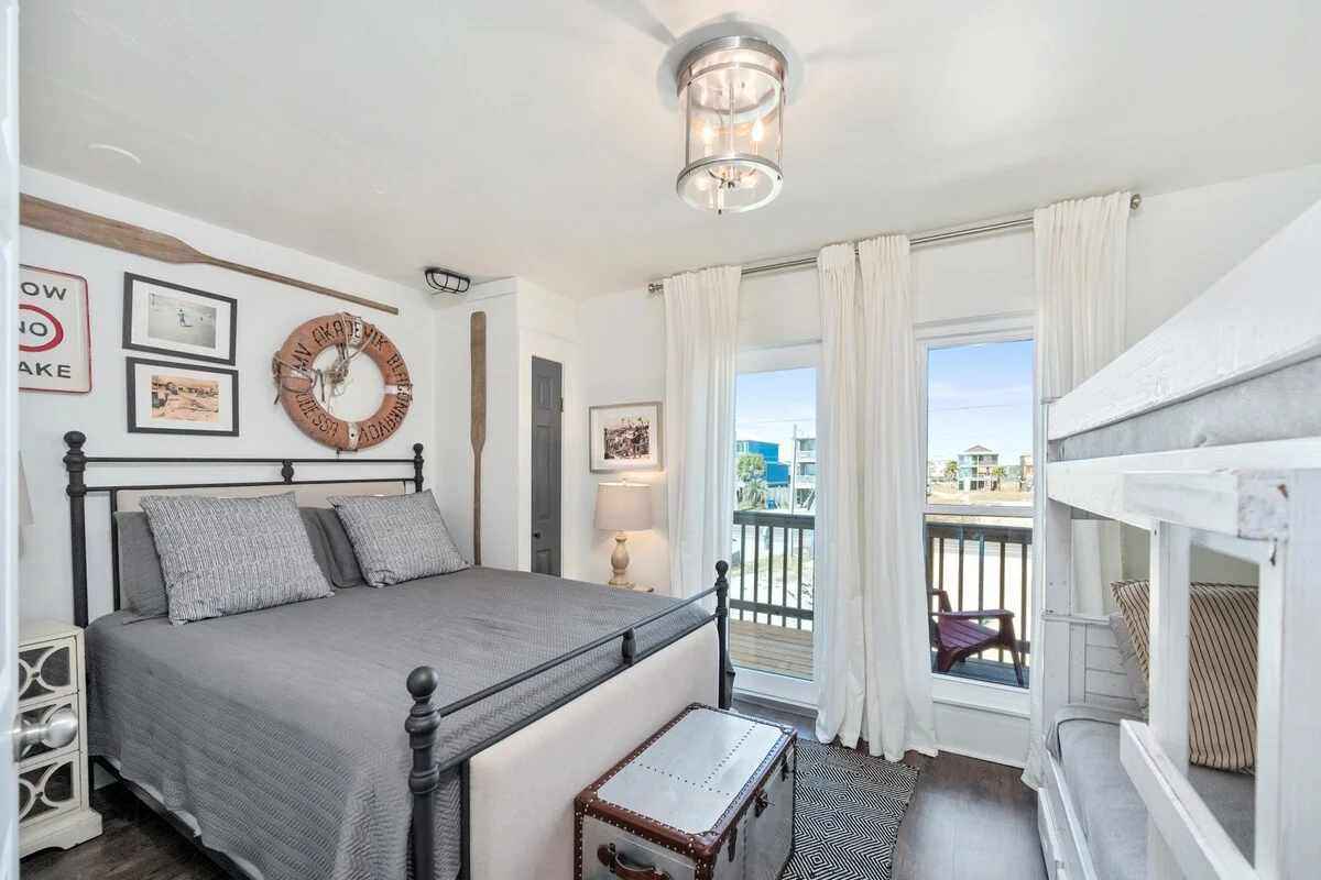 Bedroom with iron bed, bunks and balcony door, SouthWind West