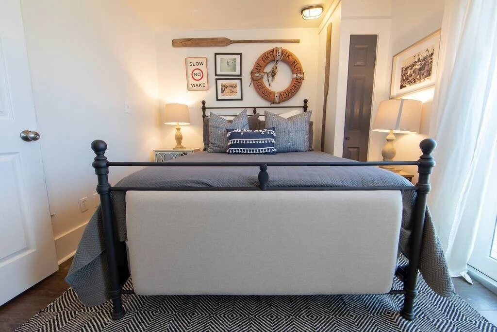 Iron queen bed with nautical decor, SouthWind West
