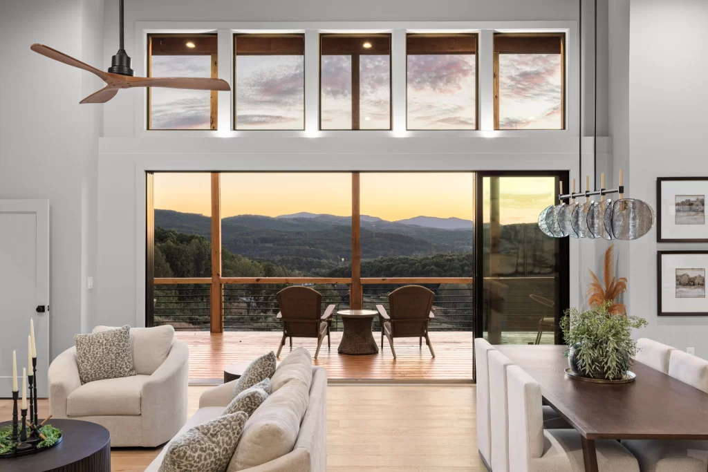 Great room with clerestory windows and a sunset mountain view through the deck doors, View Finder II