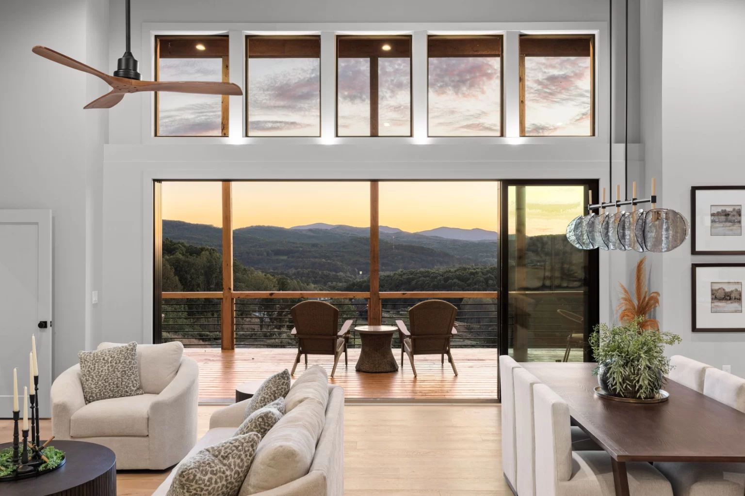 Great room with clerestory windows and a sunset mountain view through the deck doors, View Finder II