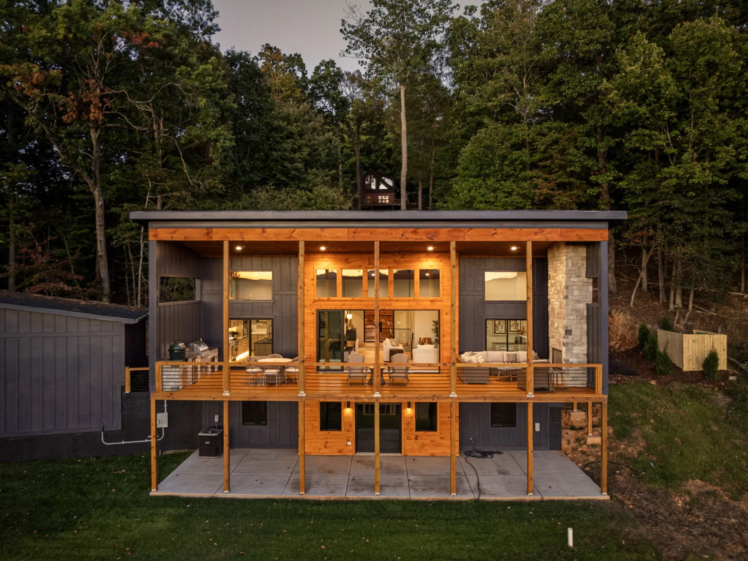 Back of the home at dusk with the covered deck lit, View Finder II