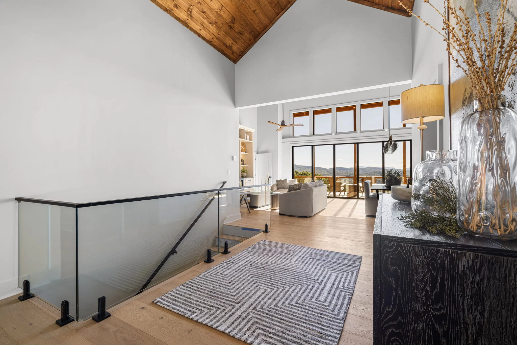 Entry with a glass stair rail, looking into the great room, View Finder II