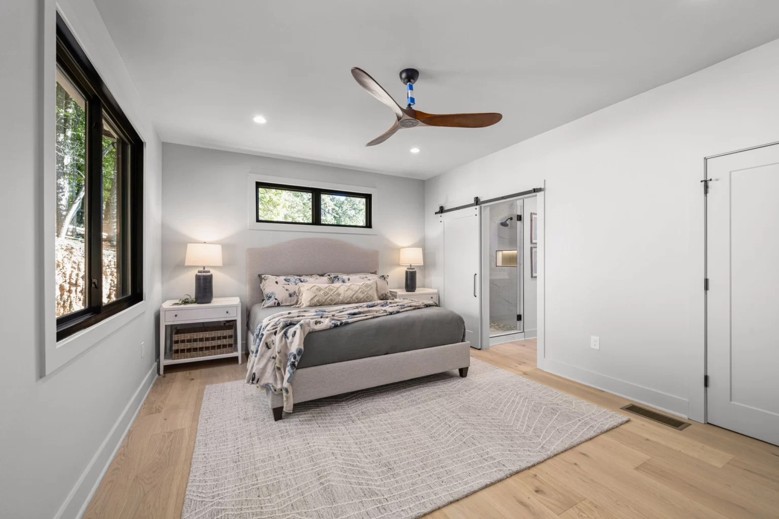 Bedroom with a barn door to its ensuite bathroom, View Finder II